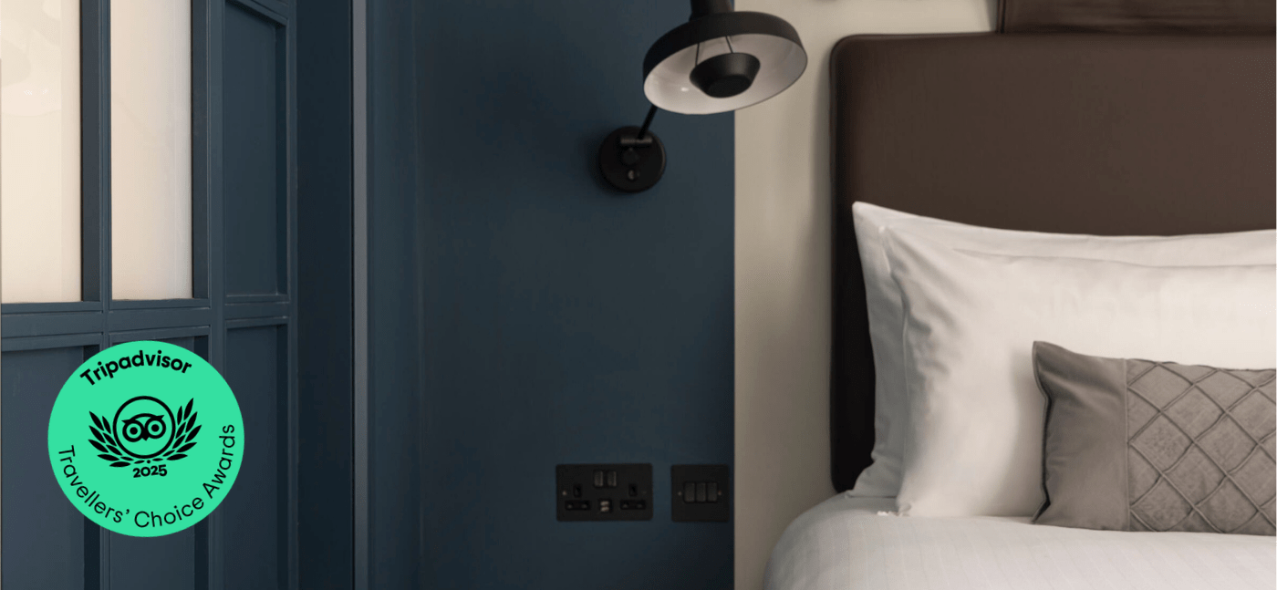 Bedroom with TripAdvisor Travellers Choice Award logo